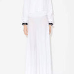 Front view of white batwing jumper on model wearing white maxi dress underneath, against a white background.