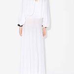 Back view of white batwing jumper on model wearing white maxi dress underneath, against a white background.