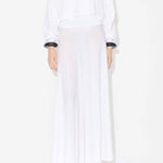 Front view of linen white dress on model wearing white pullover, and natural wedge sandals, against white background.