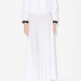 Front view of linen white dress on model wearing white pullover, and natural wedge sandals, against white background.