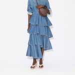 Front view of bleu mineral spiral skirt on model wearing denim top and natural sandals, against a white background.