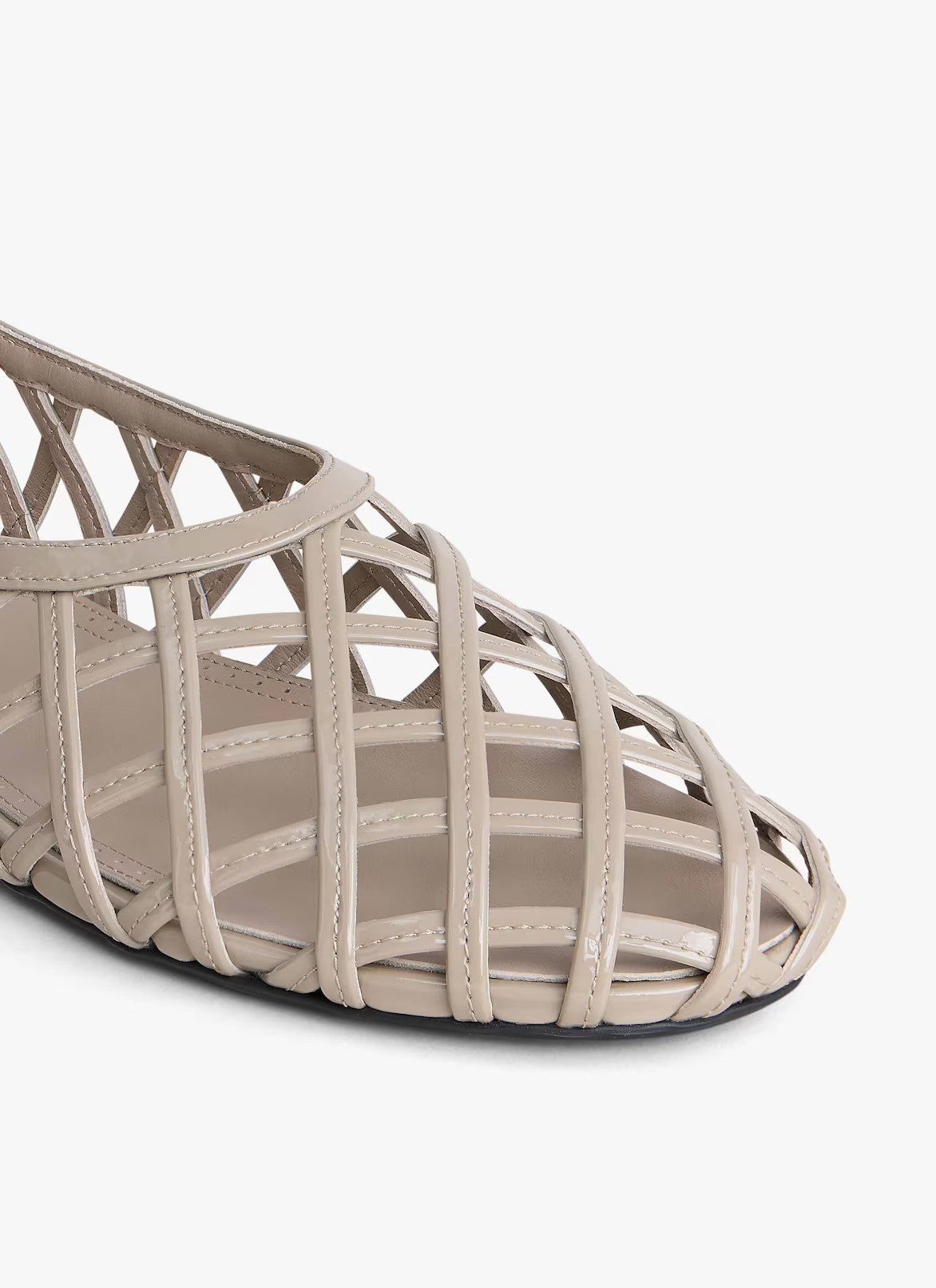 Closeup side view of grey cage ballet flats on white background, with no model shown.