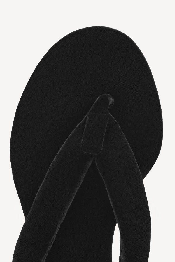 Overhead view of left heel thong mule in velvet on white background, with no model shown.