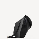 Side view of noir hip east west bag on white background, with no model shown.