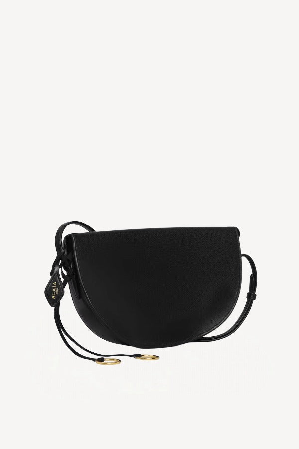 Back view of noir hip east west bag on white background, with no model shown.