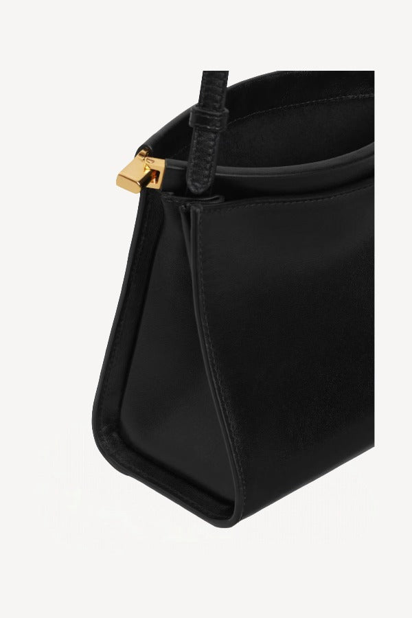 Open view of noir le click small square bag on white background, with no model shown.