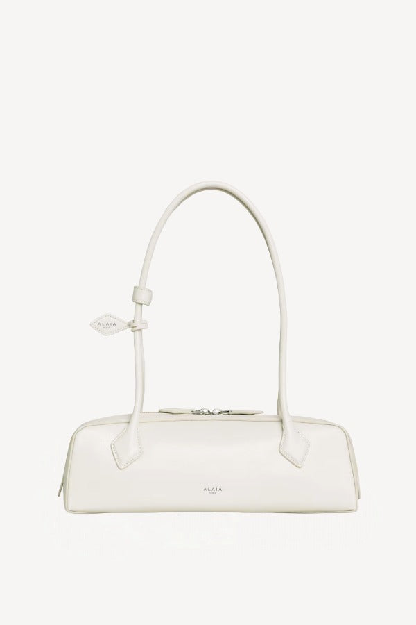 Front view of ivoire le teckel medium bag on white background, with no model shown.