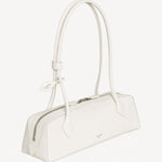 Side slanted view of ivoire le teckel medium bag on white background, with no model shown.