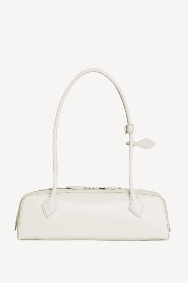 Back view of ivoire le teckel medium bag on white background, with no model shown.