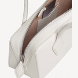 Zipper open bag view of ivoire le teckel medium bag on white background, with no model shown.