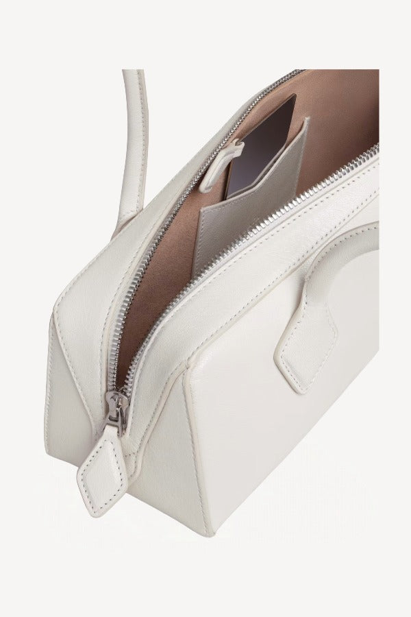 Zipper open bag view of ivoire le teckel medium bag on white background, with no model shown.