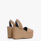 Back slanted view of natural wedge slingback in paper straw.