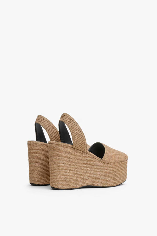 Back slanted view of natural wedge slingback in paper straw.