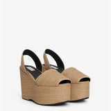 Front slanted view of natural wedge slingback in paper straw, against a white background with no model shown.