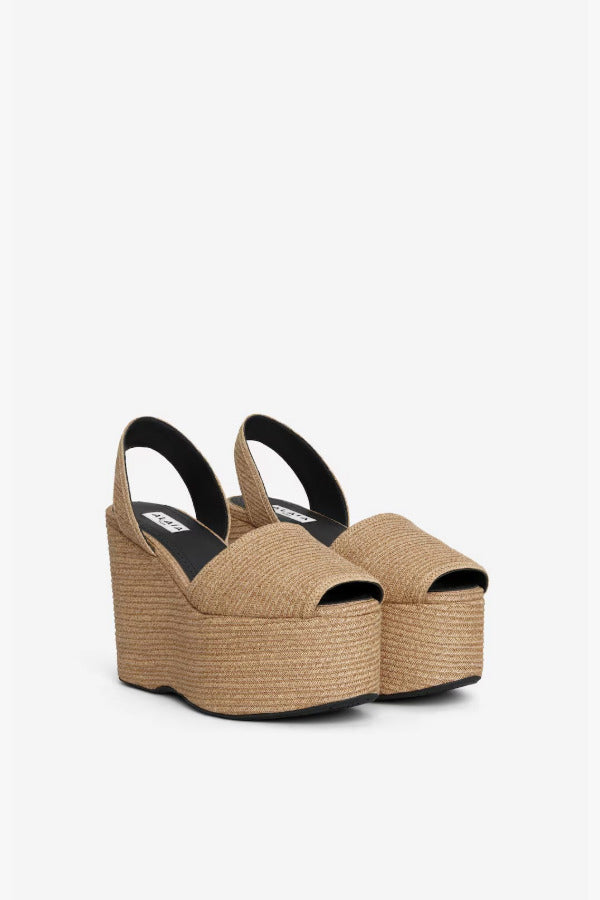 Front slanted view of natural wedge slingback in paper straw, against a white background with no model shown.