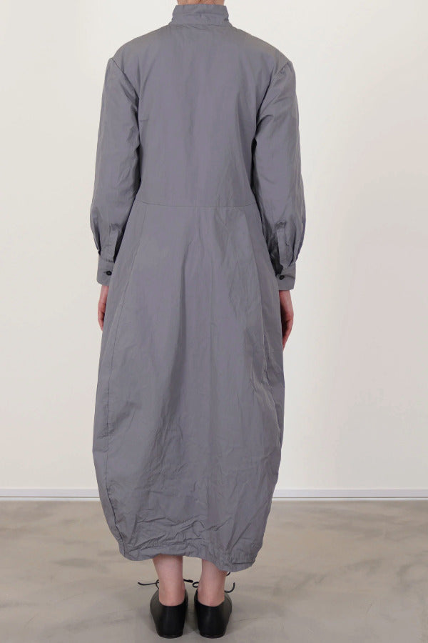 Back view of fog letty dress on model wearing black oxfords, against a white background.