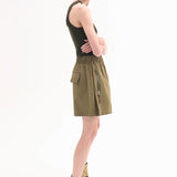 Side view of olive combat short on model wearing a dark green tank top and leather wrap sandals on white background.