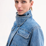 Front side closeup view of cropped military jacket on model, against white background.