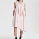 Front view of blush pink azelia dress on model wearing black sneakers and socks, against a white background.