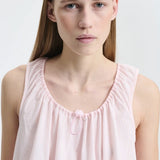 Front closeup view of blush pink azelia dress on model, against a white background.