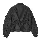 Back view of black Birdie Jacket on white background, with no model shown.