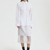 Front view of white braxton shirt on model wearing white slip and black sneakers, against a white background.