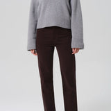 Front view of barrister caia pants on model wearing grey sweater and heels, against a white background.