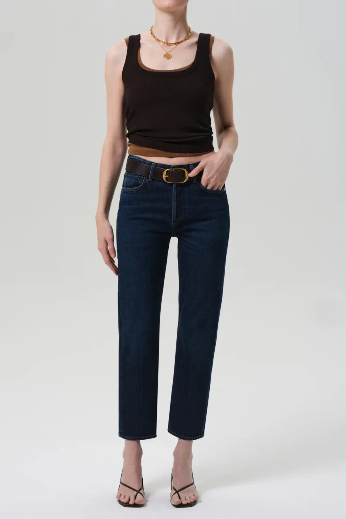 Front view of blaine jean in medina on model wearing black and brown tank tops with black heels, against a white background.