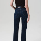 Back view of blaine jean in medina on model wearing black and brown tank tops with black heels, against a white background.