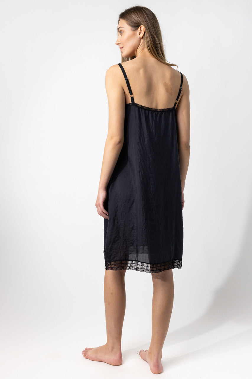 Back view of midnight chemise slip on model, against a white background.