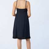 Back view of kymber slip on model wearing natural sandals, against a white background.