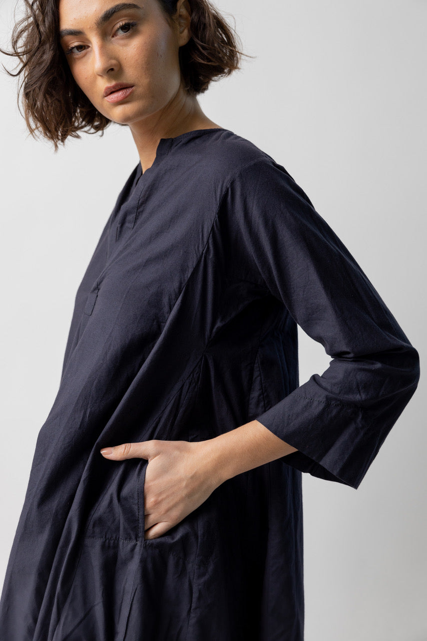 Side closeup view of midnight short tule dress on model, against a white background.