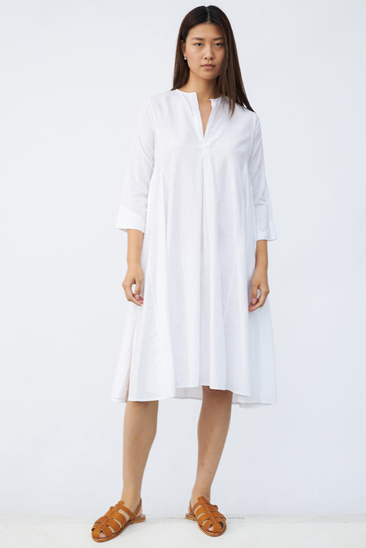 Front view of rice short tule dress on model wearing natural sandals, against a white background.