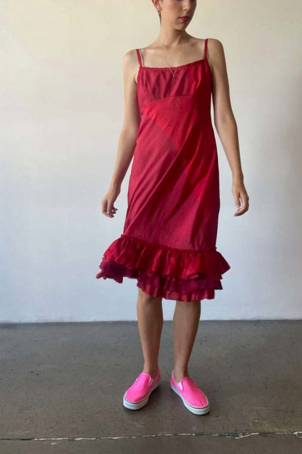Front view of lipstick slip with ruffles on model wearing pink sneakers, against a white background.