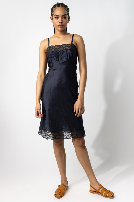 Front view of midnight susan slip on model wearing natural sandals, against a white background.