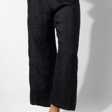 Front closeup view of midnight wide leg pants on model wearing midnight top, against a white background.