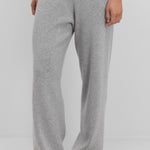 Front view of grey no 320 rush trouser on model wearing white t-shirt and sandals, against a white background.