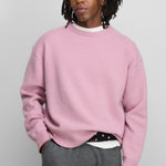 Front view of rosa no 431 mike sweater on model wearing grey pants, against a white background.