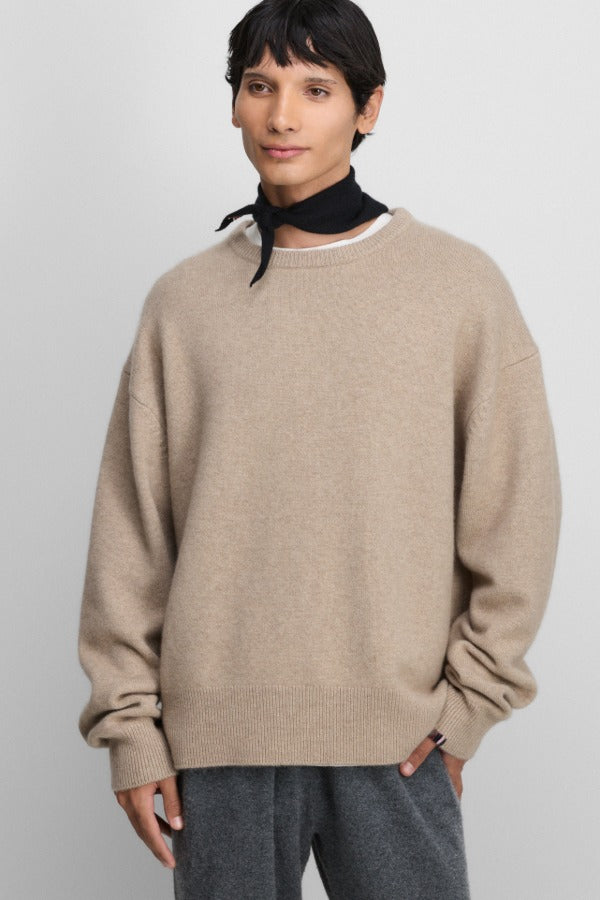 Front view of oat no 431 mike sweater on model wearing grey pants, against a white background.