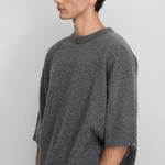 Front slanted view of felt no 433 sassie sweater on model wearing black pants, against a white background.