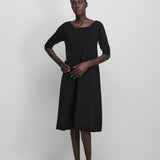 Front view of raven no 439 gina dress on model wearing black heels, against a white background.