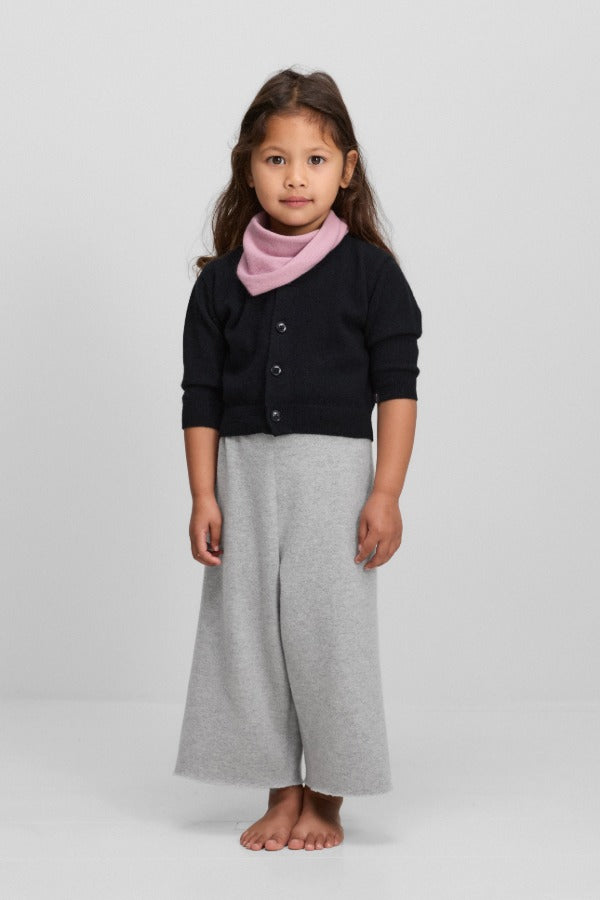 Front view of raven no 440 toddler cardigan on model wearing grey pants, against a white background.
