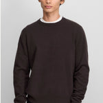 Front view of oat no 444 hat on model wearing brown sweater and black pants, against a white background.