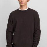 Front view of oat no 444 hat on model wearing brown sweater and black pants, against a white background.