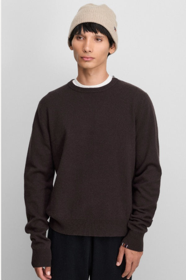 Front view of oat no 444 hat on model wearing brown sweater and black pants, against a white background.