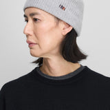 Side view of grey no 444 hat on model wearing black sweater, against a white background.