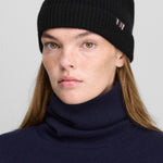 Front view of raven no 444 hat on model wearing navy sweater, against a white background.