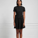 Front view of raven girl skirt on black haired model wearing short sleeve black henley and maroon mary janes.