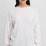 Front view of snow aries sweater on model wearing black trousers, against a white background.