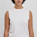 Front view of snow payer top on model wearing black pants, against white background.